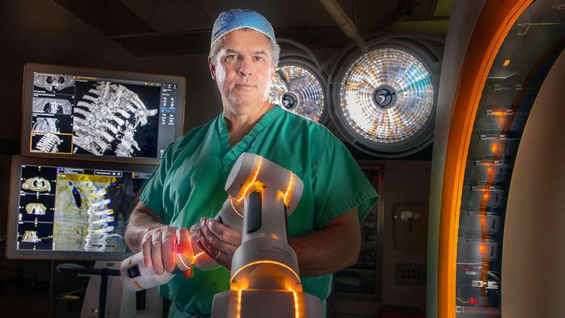 Robotic Spine Surgery with doctor holding robot